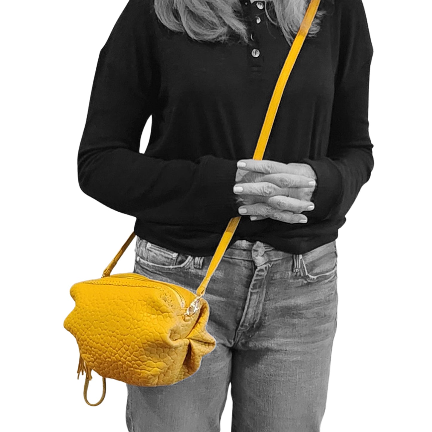 Close-up of the Maybach's Mucha Bag’s textured embossed logo tag sewn onto the deep burgundy leather surface