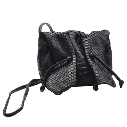 Close-up of the Python Mini Butterfly Bag’s textured crocodile pattern embossed on its top flap and gold-tone clasp detail.