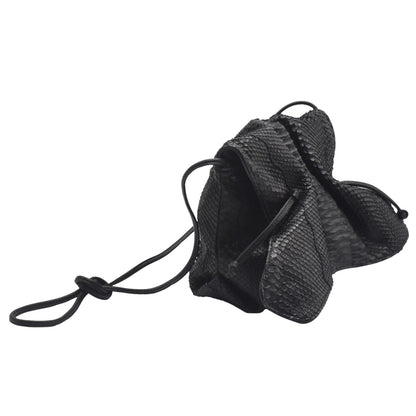 Close-up of the Python butterfly bag’s textured leather surface with intricate natural scales and rich amber hue detail.