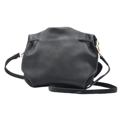 Close-up of the Butterfly Bag’s textured faux leather surface with subtle stitching detail and vibrant teal color from a