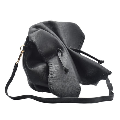 Close-up of the Butterfly Bag’s textured leather surface with vibrant magenta and purple hues, highlighting intricate