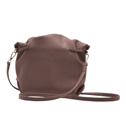 Close-up of the Butterfly Bag’s textured leather surface and vibrant teal zipper pull detail from an angled top view.