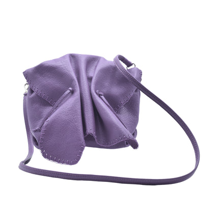 Close-up of the Butterfly Bag's textured faux leather surface with subtle floral embossed details and a glimpse of its