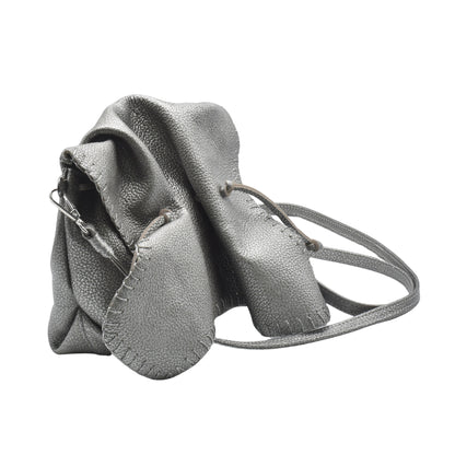 Close-up of the Butterfly Bag’s textured leather surface with intricate stitching and vibrant yellow and black color details.