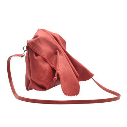 Close-up of textured genuine leather handle featuring intricate stitching and a gold-tone clasp on the Butterfly Bag