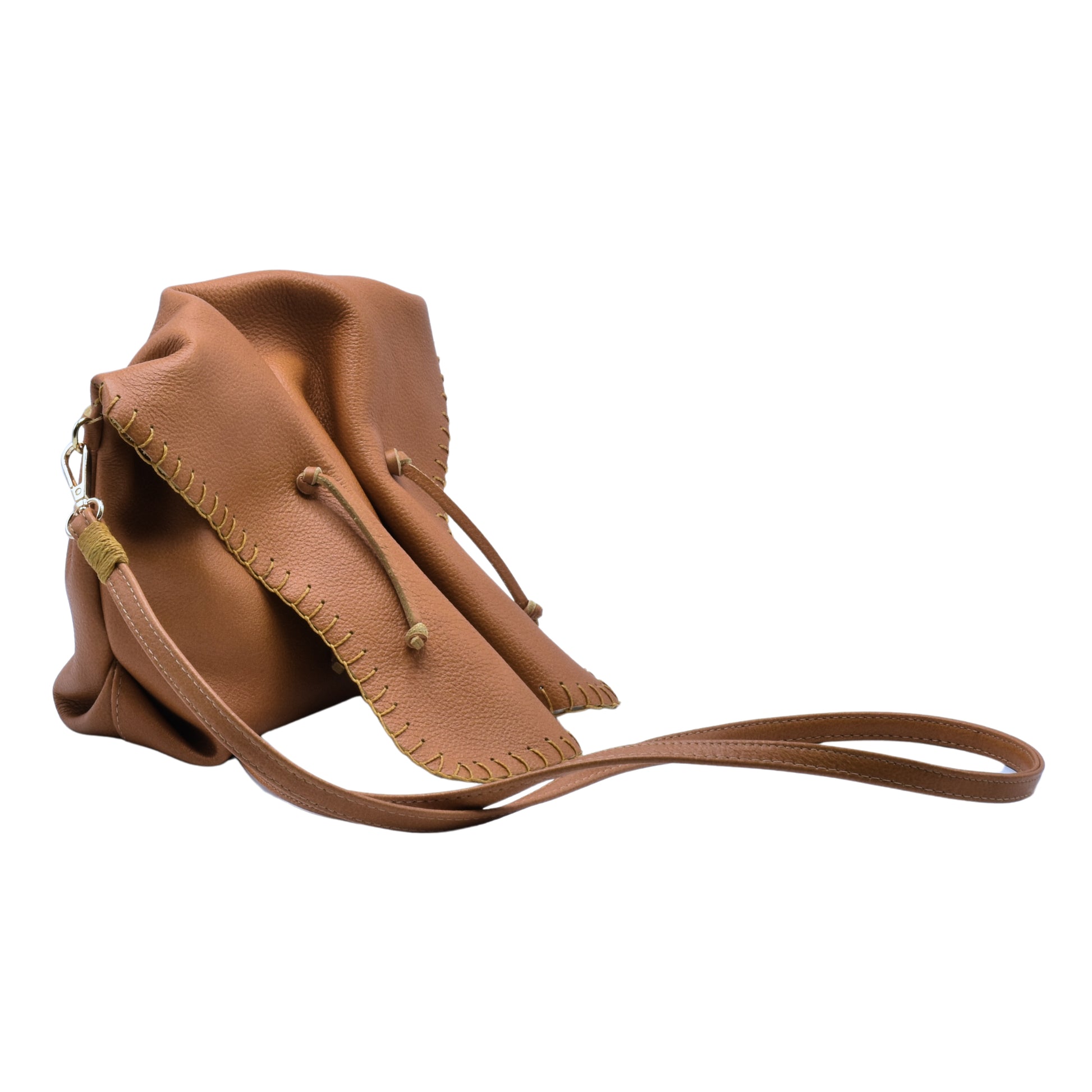 Close-up of the Butterfly Bag's textured leather surface with gold zipper detail and subtle floral embossed pattern.