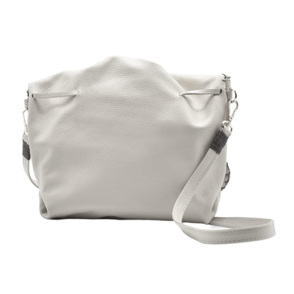 Close-up of the Butterfly Bag’s textured pink faux leather surface with subtle stitching details and a partial view of the