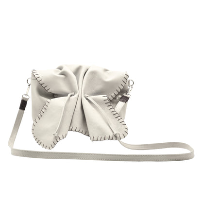 Close-up of the Butterfly Bag's textured faux leather surface with embossed floral pattern and gold-tone zipper pull detail.