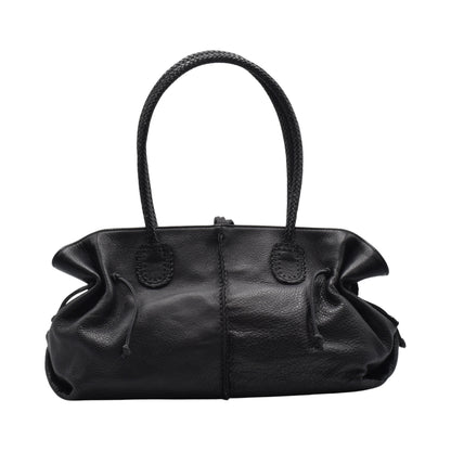 Close-up of the textured saffiano leather surface on the Signature Satchel, highlighting the fine crosshatch pattern and