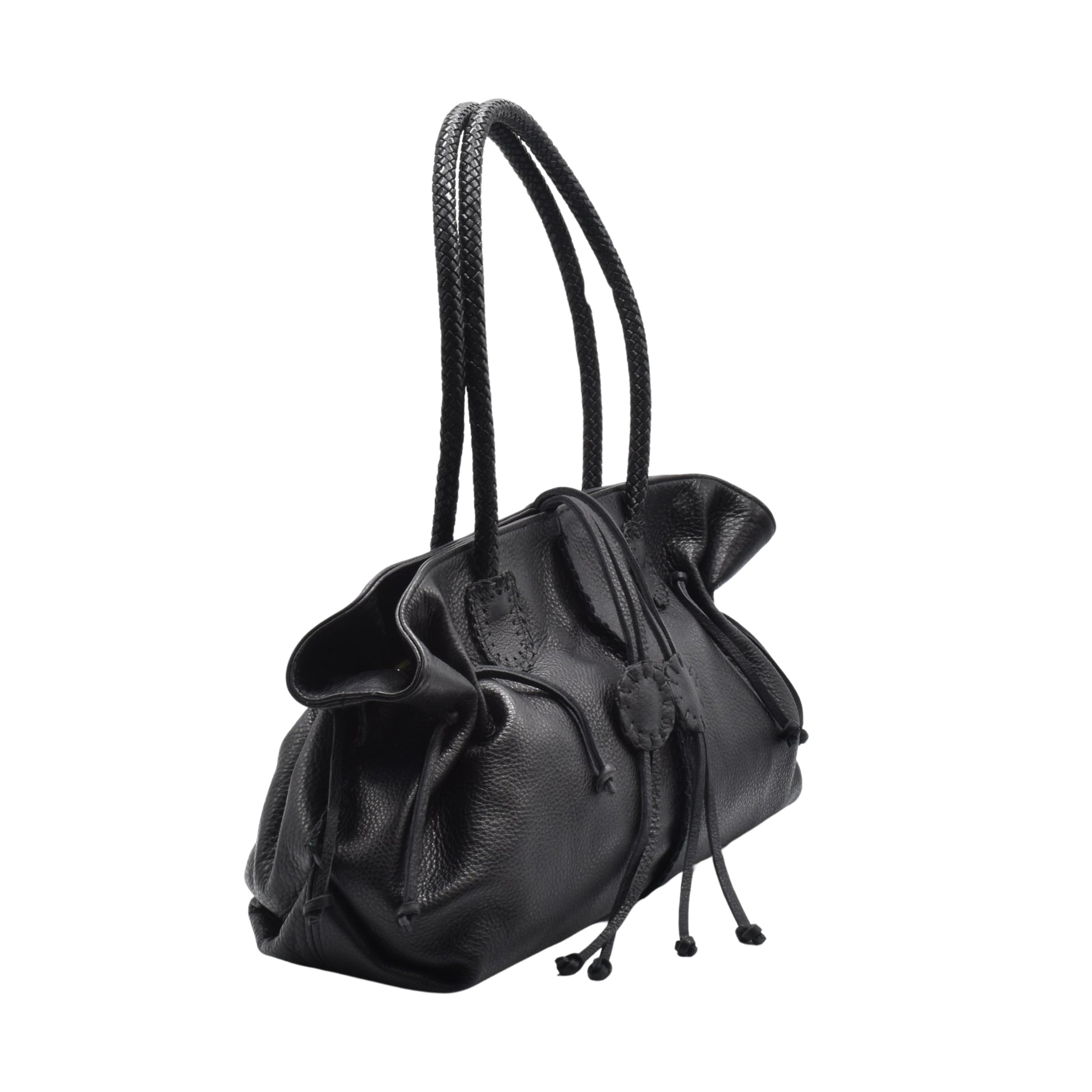 Close-up of gold-tone metal logo plate on textured pebbled leather front flap of Signature Satchel showing fine stitching