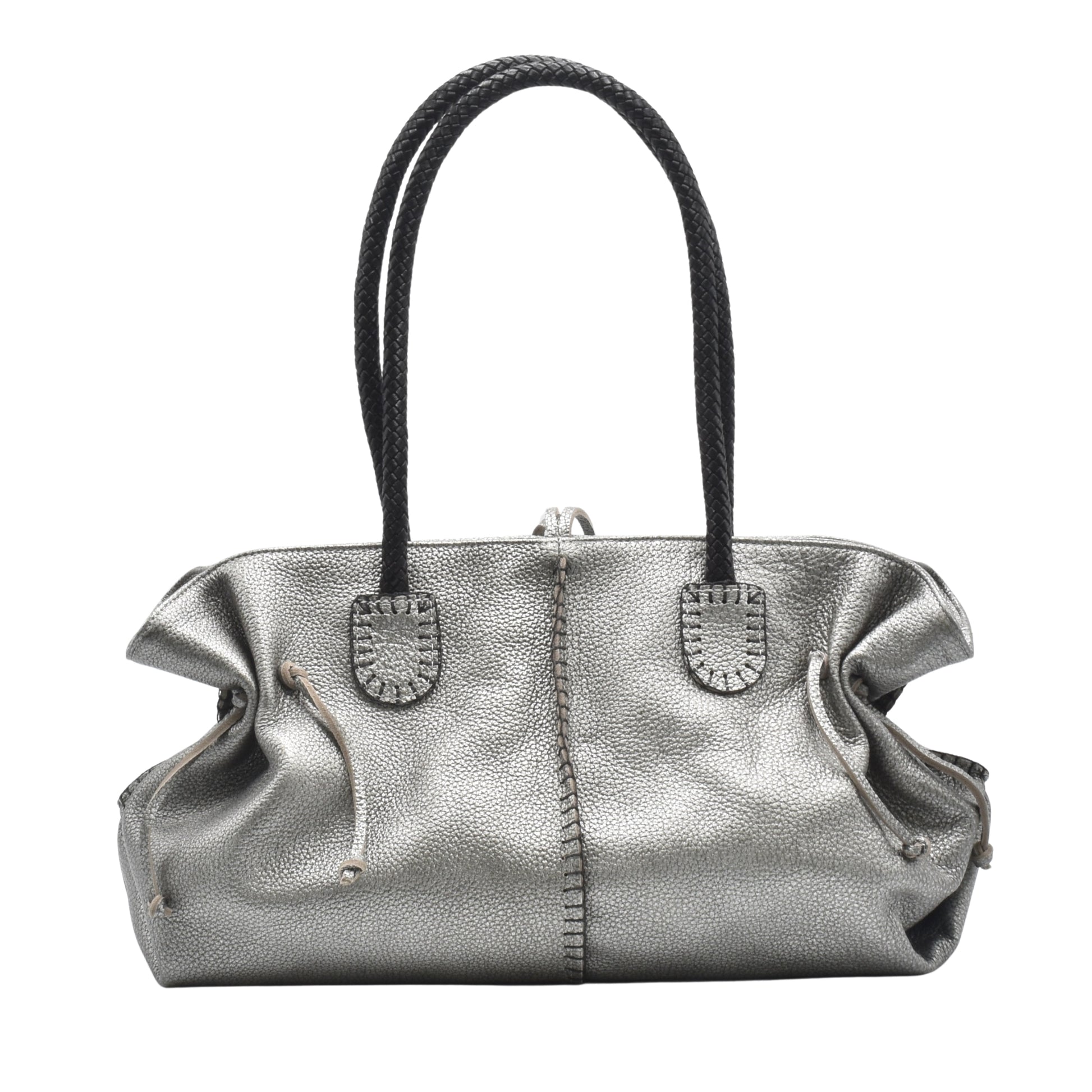 Close-up of textured pebbled leather handle with gold-tone hardware on the Signature Satchel from an upper-left angle.