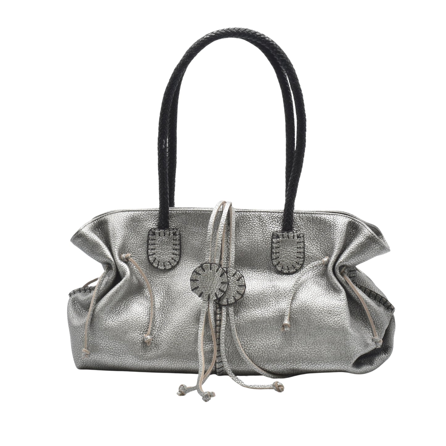 Close-up of textured honey-colored leather handle with subtle stitching on the Signature Satchel, highlighting craftsmanship