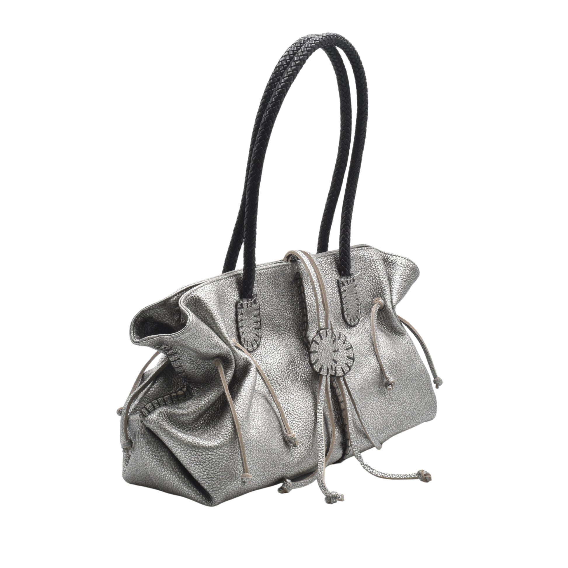 Close-up of the Signature Satchel's textured pebbled leather surface with silver zipper pull and intricate stitching details