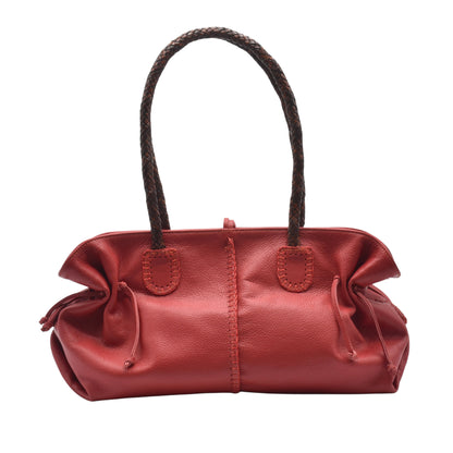 Close-up of textured crocodile-embossed leather surface on the signature satchel handle strap detail