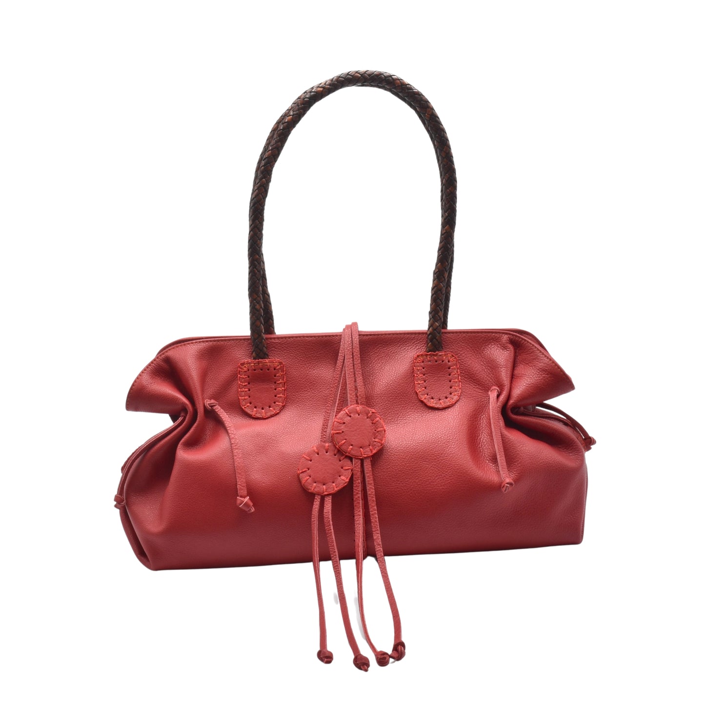 Close-up of the Signature Satchel’s textured pebble leather surface with gold hardware accent and top handle stitching