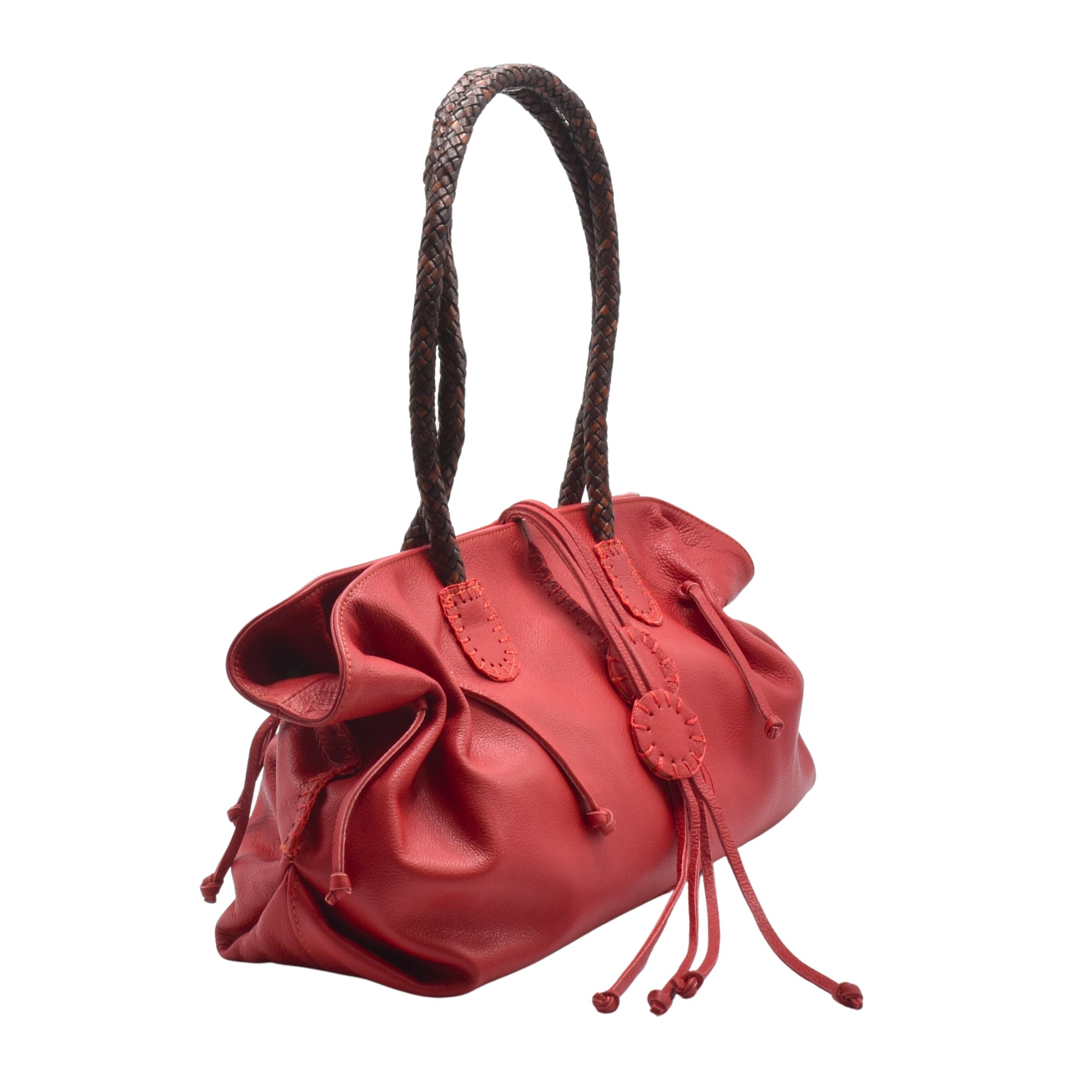 Close-up of textured saffiano leather surface with stitched edges and embossed logo on the front flap of the Signature