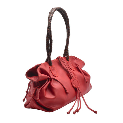 Close-up of textured saffiano leather surface with stitched edges and embossed logo on the front flap of the Signature