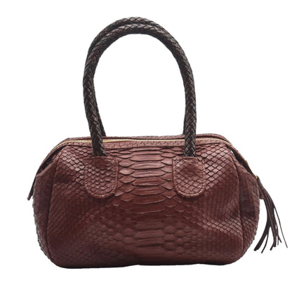 Close-up of the mini barrel's tightly woven python leather texture and rich natural color highlighting intricate pattern