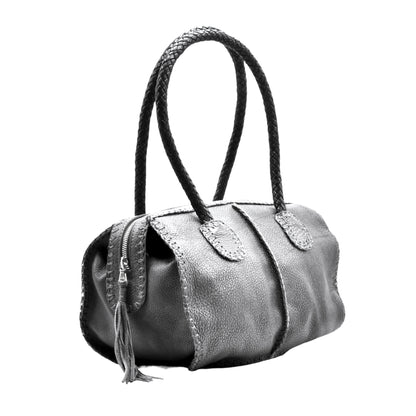 Close-up of the textured wood grain and rich caramel finish on the barrel’s curved surface, highlighting craftsmanship