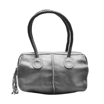 Close-up of the textured, dark brown oak barrel staves with visible wood grain and metal rivets, highlighting craftsmanship