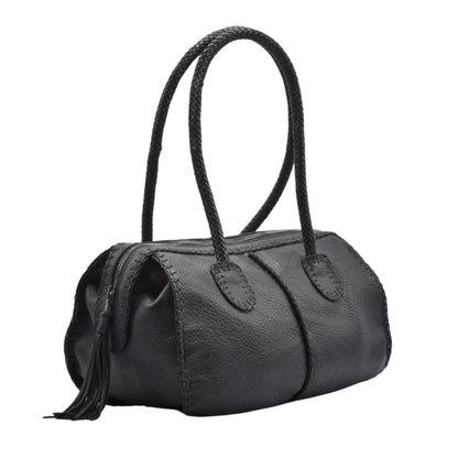 Close-up of the textured, matte wood surface with visible grain and subtle carvings on the barrel's side.