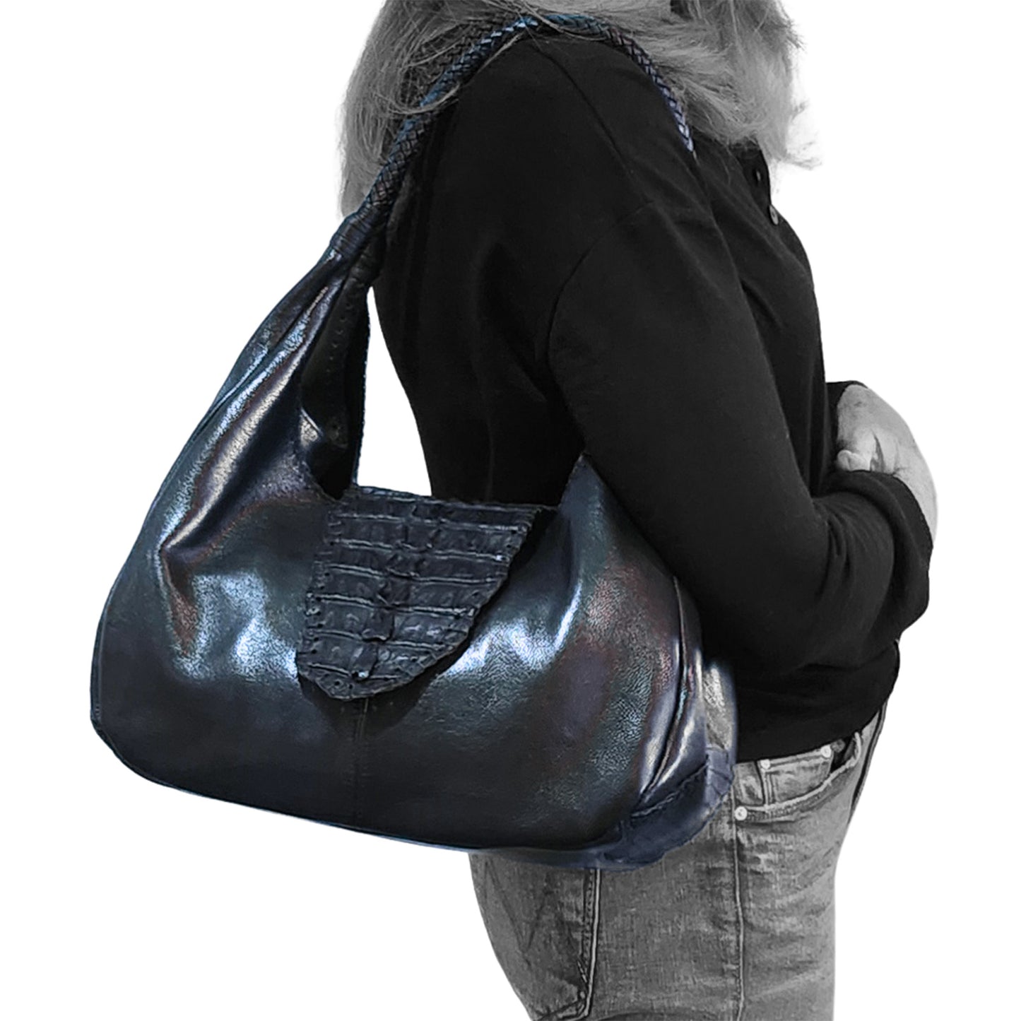Close-up of the Croc Hobo's textured pebble leather surface with visible zipper pull and stitching detail at the bag's side
