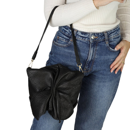 Close-up of the butterfly-shaped lambskin bag handle showcasing soft texture and intricate stitching detail.