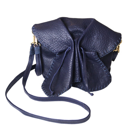 Close-up of the Butterfly Bag Lambskin’s textured surface highlighting natural grain and soft sheen from a slight overhead