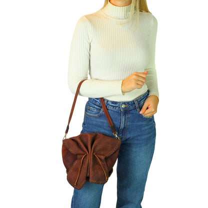 Close-up of the Butterfly Bag Lambskin's textured leather surface showcasing fine grain detail and subtle sheen from an