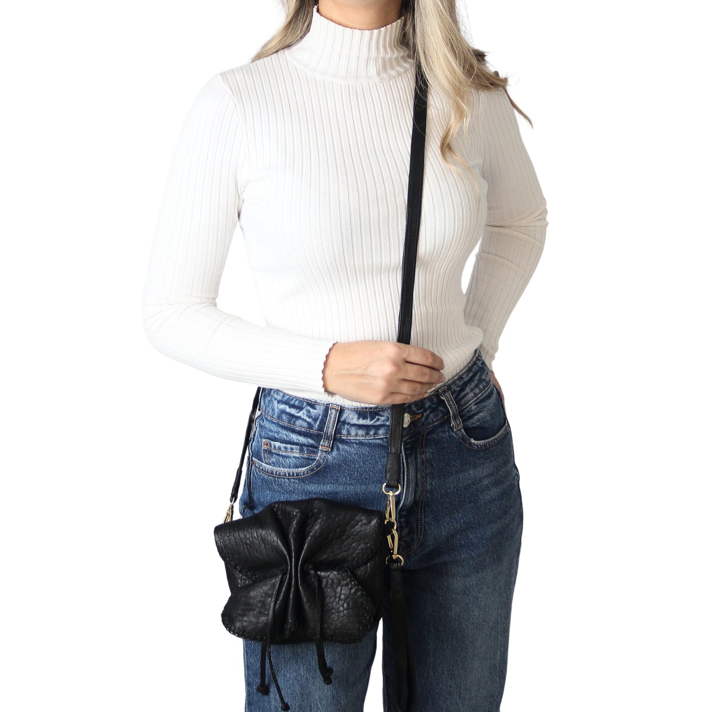 Close-up of the Mini Butterfly Bag’s delicate lambskin texture and subtle stitching details from a front-facing angle