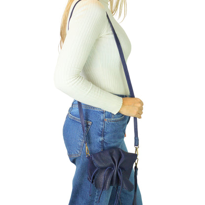 Close-up of the Mini Butterfly Bag Lambskin's textured surface with subtle stitching details and a glimpse of the delicate