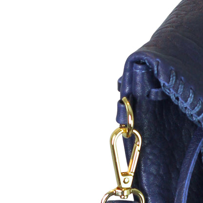 Close-up of the Mini Butterfly Bag’s smooth lambskin surface with delicate stitching detail and subtle sheen from an angled