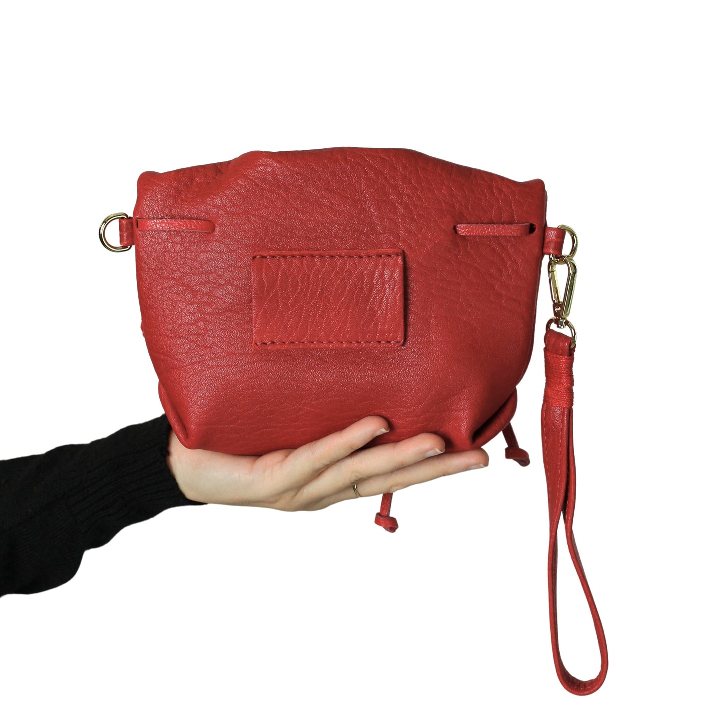 Close-up of the mini butterfly bag’s lambskin leather texture with subtle stitching details and a glimpse of its compact