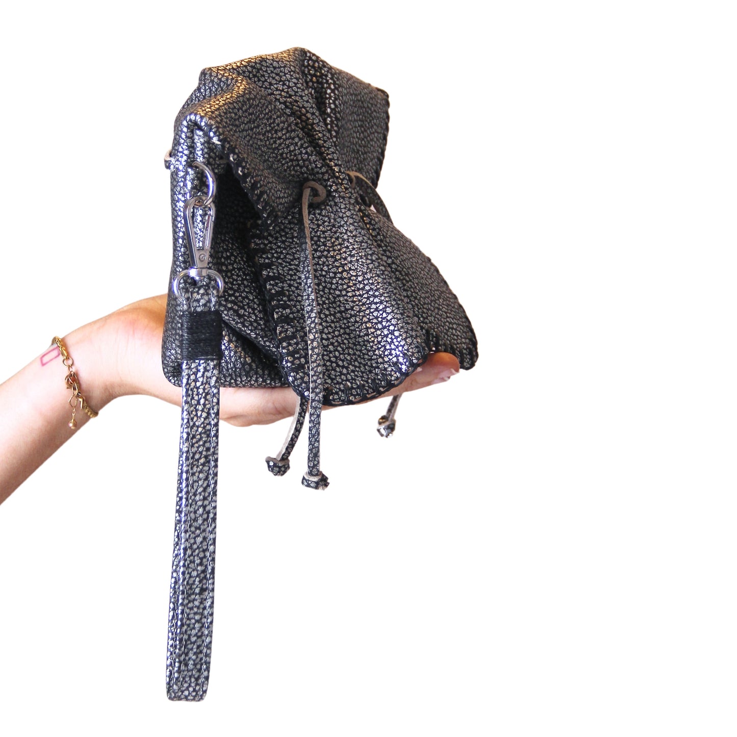 Close-up of the Mini Butterfly Bag Lambskin’s textured leather surface with subtle stitching details and a hint of its