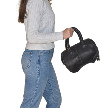 Close-up of the Mini Barrel's textured wooden surface showing natural grain and small metal band detail.