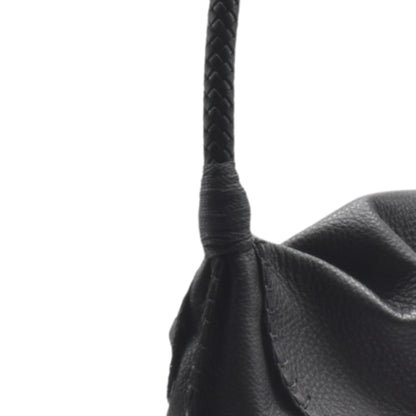 Close-up of the Shoulder Butterfly Bag’s textured beige leather surface with subtle stitching details and a visible