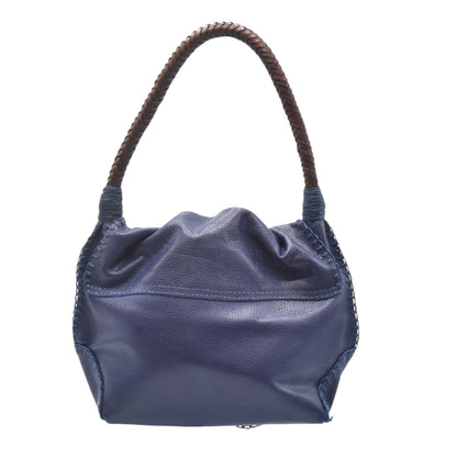 Close-up of the shoulder Butterfly Bag’s textured faux leather surface with visible stitching and a gold-tone metal clasp