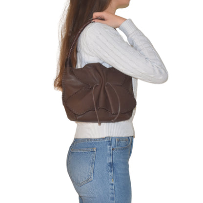 Close-up of the Shoulder Butterfly Bag’s textured faux leather surface with visible fine stitching and embossed logo detail