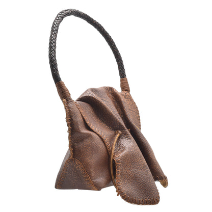 Close-up of the shoulder butterfly bag’s textured leather surface with visible stitching and a decorative gold clasp detail.