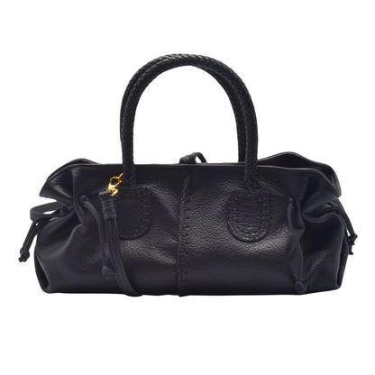 Mini satchel strap latch and textured pebbled leather surface shown from upper front corner, highlighting hardware details