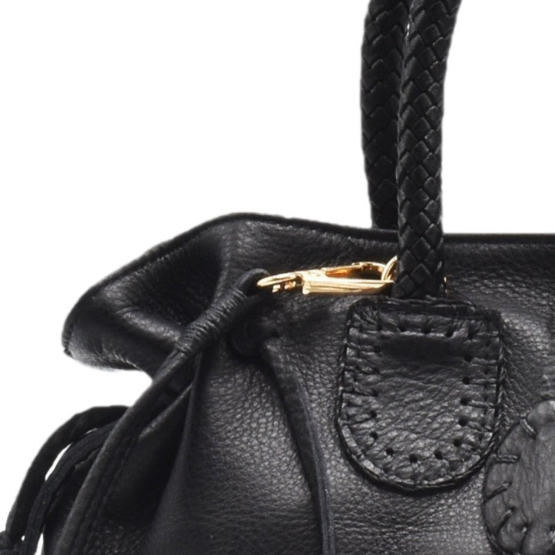 Close-up of the Mini Satchel’s textured pebble leather surface with gold-tone zipper pull and subtle logo embossing detail.