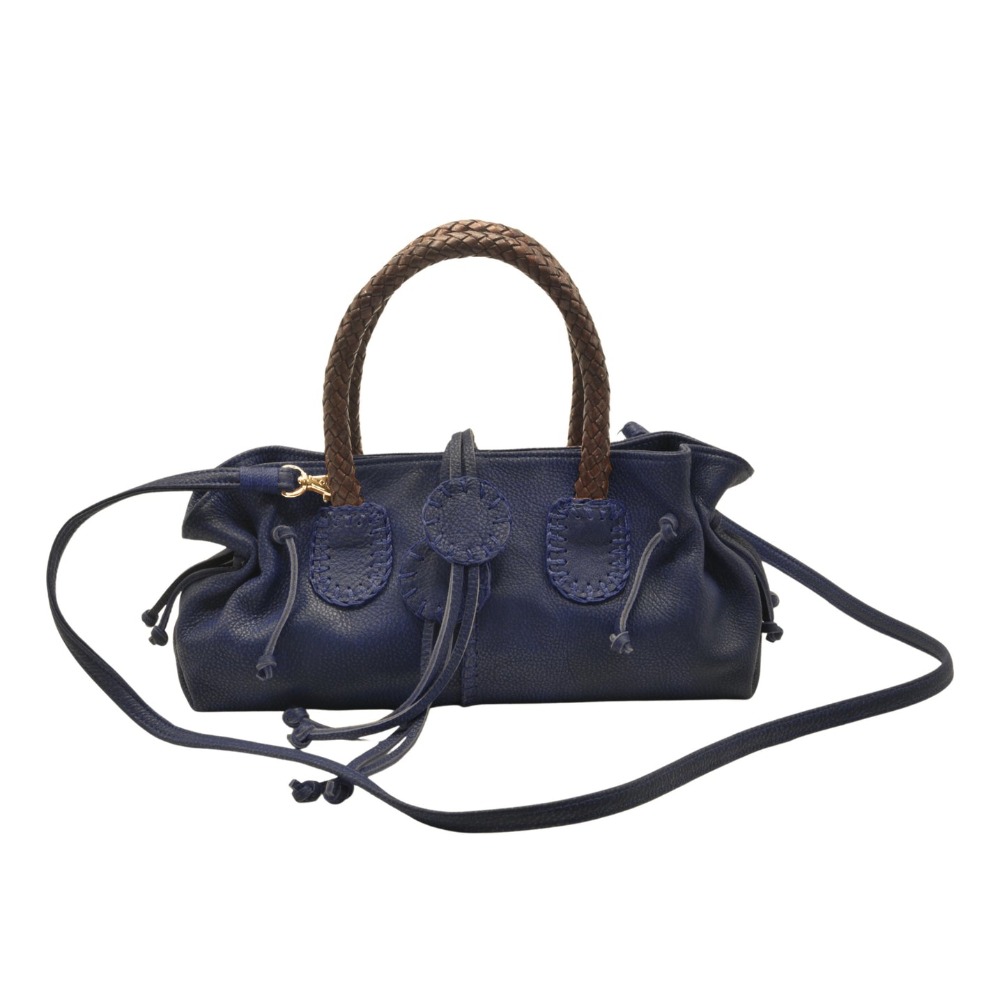 Close-up of the Mini Satchel’s textured saffron leather surface with subtle stitching detail and a clip-lock clasp in matte