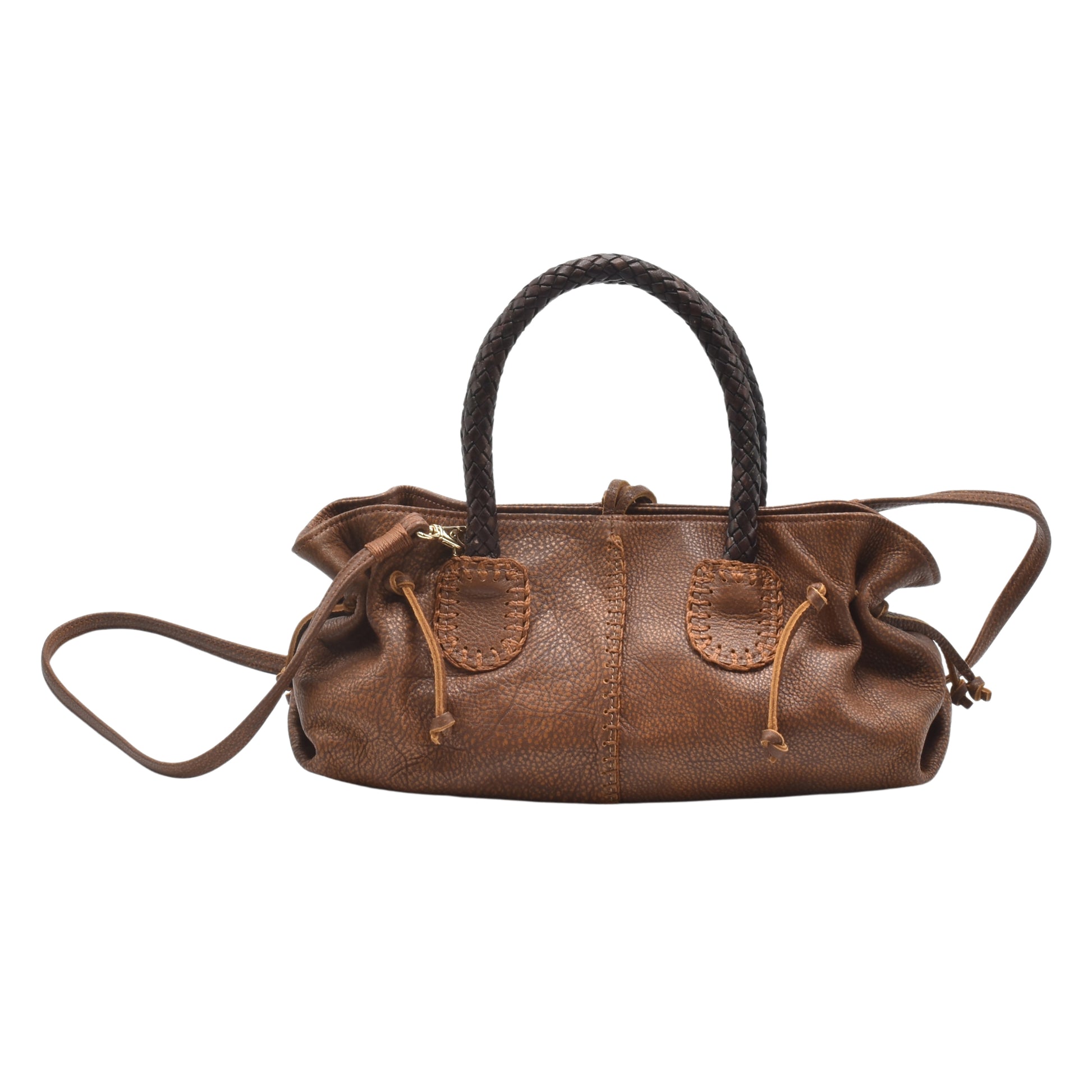 Close-up of the textured black leather surface and gold-toned clasp detail on the Mini Satchel's front panel.