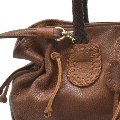 Close-up of the Mini Satchel’s textured faux leather surface with subtle stitching details and a gold-tone zipper pull.