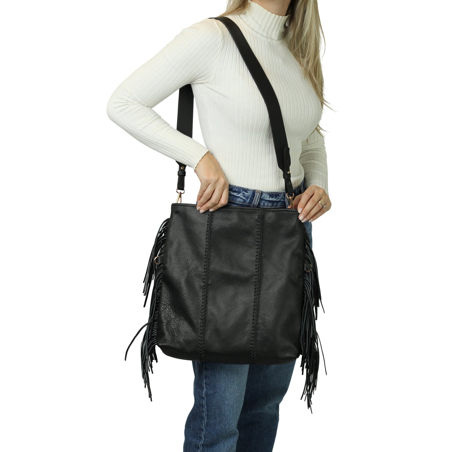 Close-up of the Large Fringe Crossbody Messenger's textured leather flap with metal rivet accents and detailed fringe trim.