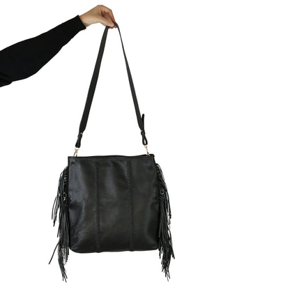 Close-up of the large fringe detailing and textured metal crossbody chain showing intricate bead accents and clasp closure