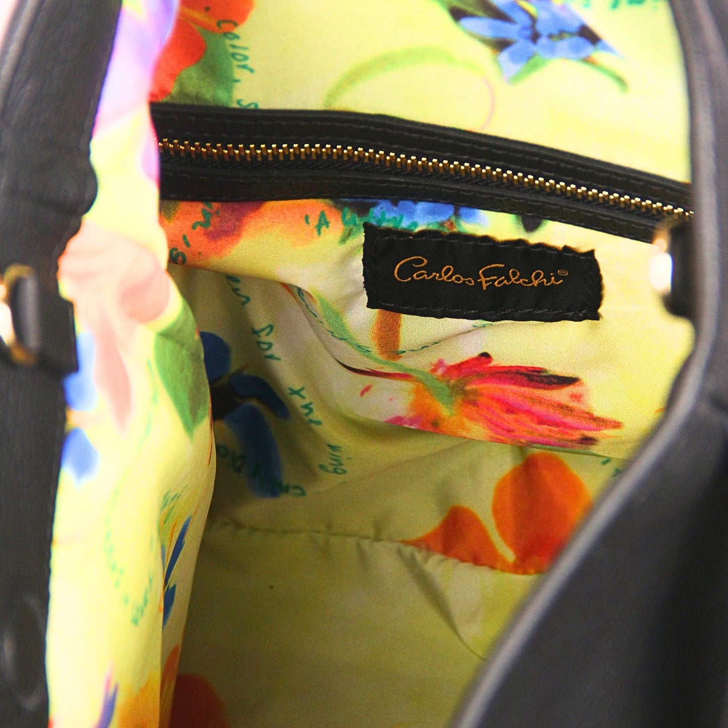 Close-up of the large gold-tone fringe detailing hanging from the crossbody strap, highlighting the layered chain and