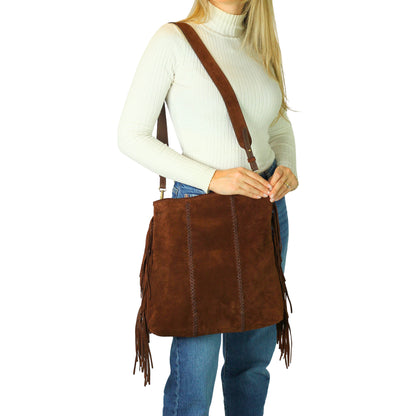 Close-up of the large fringe detailing on the crossbody strap, showcasing textured leather and metallic accents from a side