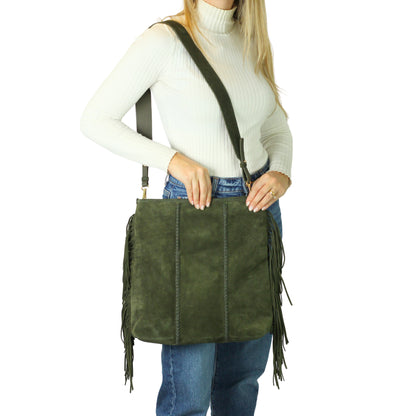 Close-up of the large fringe detailing and textured leather flap with gold-tone metal clasp on the crossbody strap from a