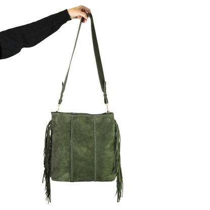 Close-up of the large fringe tassel detail with textured leather strap and silver-tone metal clasp on the crossbody